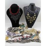 A QUANTITY OF COSTUME JEWELLERY, to include many stone set necklaces etc.