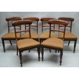 A SET OF SIX 19TH CENTURY MAHOGANY SINGLE DINING CHAIRS, ring turned fore supports, overstuffed