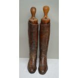 A PAIR OF TAN LEATHER RIDING BOOTS with wooden trees