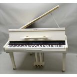 A SUZUKI DIGITAL PIANO OF BOUDOIR BABY GRAND DESIGN, in white, with brass castors and pedals,