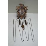 A SMALL BLACK FOREST CUCKOO CLOCK, floral painted decoration, cast pine cone weights, the case
