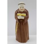 A ROYAL WORCESTER BONE CHINA CANDLE SNUFFER, modelled and painted as a monk with an open book, 12.