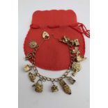 A 9CT GOLD CHARM BRACELET, containing fourteen 9ct gold charms, with a 9ct gold padlock form
