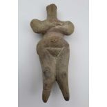 A EUROPEAN STEATOPYGOUS FERTILITY GODDESS STONEWARE FIGURE, possibly Neolithic period c. 5th