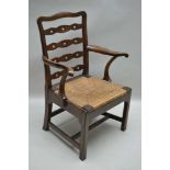 A 19TH CENTURY MAHOGANY FRAMED LADDER BACK OPEN ARMCHAIR, with woven rush seat