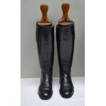 A PAIR OF BLACK LEATHER RIDING BOOTS with wooden trees