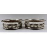 JOHN ROBERTS & CO. A PAIR OF GEORGE III SILVER WINE BOTTLE COASTERS having gadrooned rims, fluted