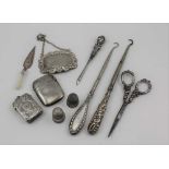 A LATE VICTORIAN SILVER VESTA CASE, Birmingham 1892, with chased decoration, together with a plain