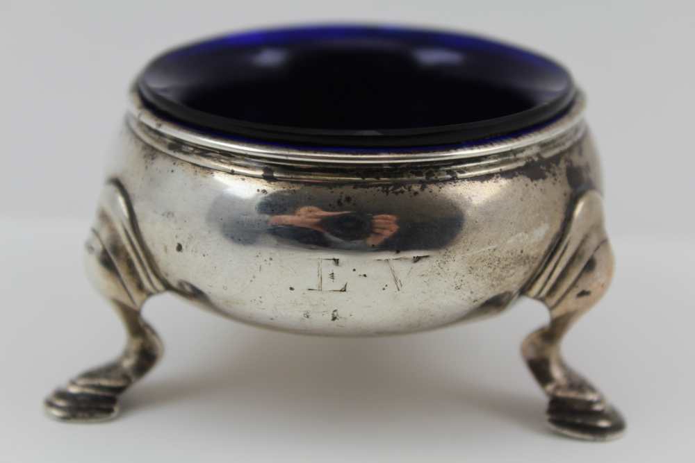 A GEORGE II SILVER SALT, raised on three cabriole supports, London 1738, possibly by James