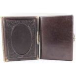 TWO VICTORIAN CARTE DE VISITE PHOTOGRAPH ALBUMS, leather bound with metal clips, one with decorative