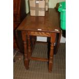 A BELIEVED J.C. BRANDED REPRODUCTION OAK TWIN FLAP DINING TABLE on turned and block legs