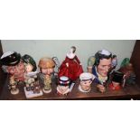 A SHELF CONTAINING A SELECTION OF ROYAL DOULTON, GOBALS and other china figurines