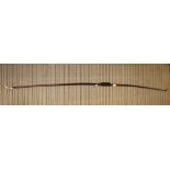 A LATE 19TH / EARLY 20TH CENTURY WOODEN LONG BOW with traditional horn end caps, having velvet grip