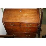 AN EARLY 19TH CENTURY BUREAU with fall down writing slope, over two slender inline drawers and two