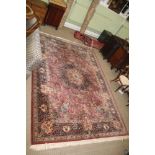 A MODERN WOVEN WOOLLEN FLOOR CARPET, dark terracotta ground, by 'Khorsabad', sold through 'Louis