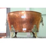 AN OVAL COPPER COAL BUCKET / PLANTER with brass lion ring mask handles and four paw feet