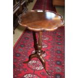 A REPRODUCTION SAUCER TOPPED WINE TABLE on slender column and three downswept legs