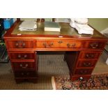 A REPRODUCTION DARK YEW WOOD FINISHED TWIN PEDESTAL DESK