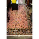 A LARGE PINK GROUND FLORAL DECORATED WOVEN WOOLEN FLOOR CARPET