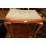 A MID 20TH CENTURY WOODEN FRAMED RECTANGULAR PAD TOPPED STOOL on cabriole legs