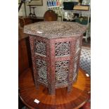 A PROBABLE INDIAN CARVED WOODEN HEXAGONAL TOPPED TABLE, on folding pierced traditional base