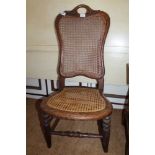 AN OAK FRAMED CONTINENTAL SINGLE CHAIR with bergere back and seat