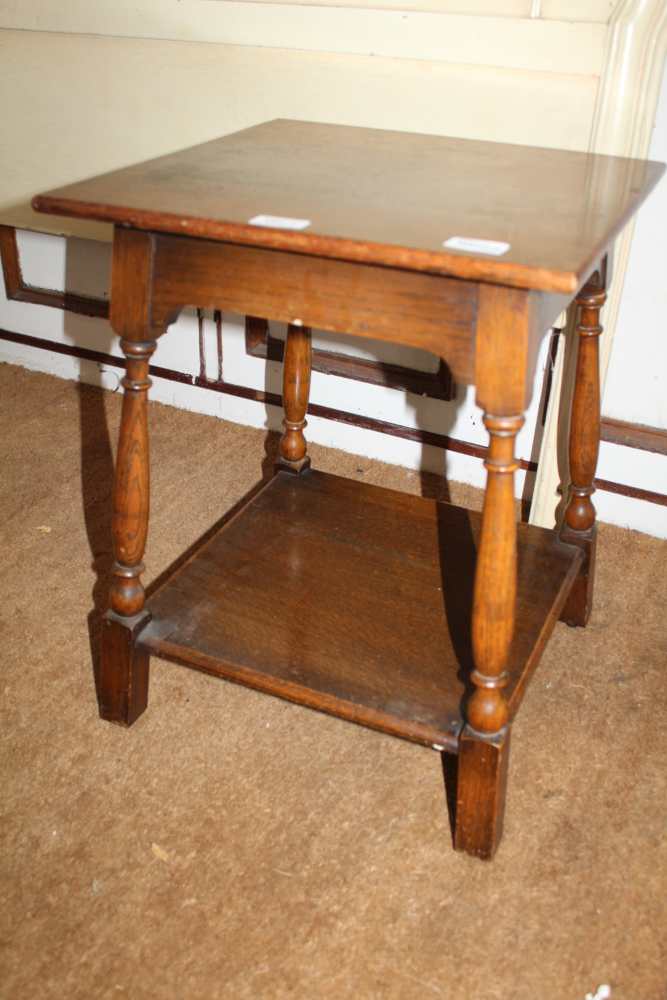 AN OAK SQUARE TOPPED COFFEE TABLE on turned and block legs, united by a plank undertier