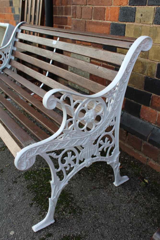 A WHITE PAINTED CAST METAL FRAMED SLATTED GARDEN TWO-SEATER BENCH together with two slatted single - Image 2 of 2