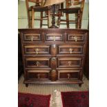 A 17TH CENTURY DESIGN OAK CHEST, having three in-line drawers over three graduating full width