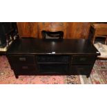 A BLACK FINISHED OVERSIZED TV STAND with a selection of audio visual storage drawers