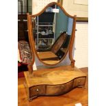 A LATE 19TH CENTURY MAHOGANY SHIELD BACK ADJUSTABLE TABLE TOP MIRROR on serpentine three drawer