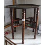 A MIDDLE EASTERN BRASS TRAY TOP TABLE on folding wooden stand