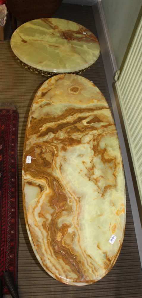 TWO ONYX TOPPED COFFEE TABLE, one circular, one oval, each supported on cast brass finished metal