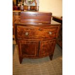 A 19TH CENTURY BOW FRONT UNIT, having single deep upper drawer over two plain panelled cupboard