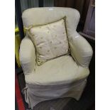 A SMALL PROPORTIONED LOW BACKED ARMCHAIR under loose cotton cover, and contrasting cushion