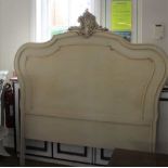A PAINTED CONTINENTAL DESIGN BEDHEAD with scrolling central crest
