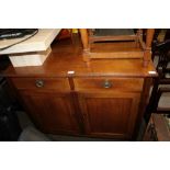 A LATE 19TH CENTURY WALNUT SIDE UNIT having two inline drawers over two plain panelled cupboard