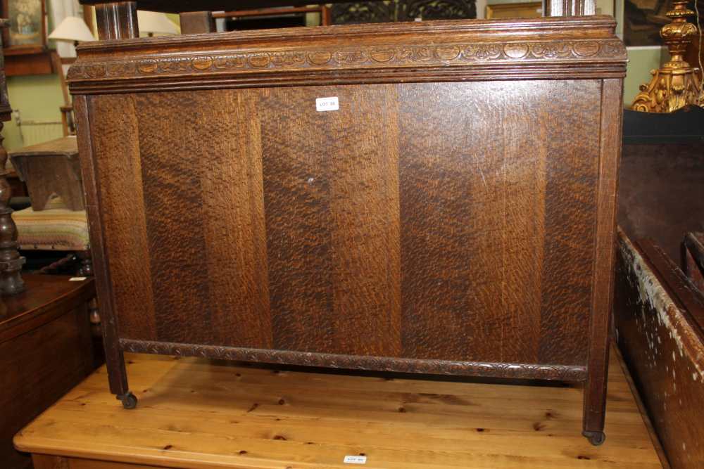 A LATE 20TH CENTURY OAK FINISHED BOX COFFER supported on short legs, with steel castors