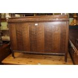 A LATE 20TH CENTURY OAK FINISHED BOX COFFER supported on short legs, with steel castors