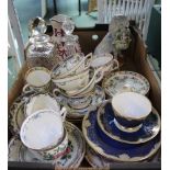 A BOX CONTAINING TWO SMALL DECANTERS & STOPPERS, CUPS & SAUCERS and a porcelain poodle