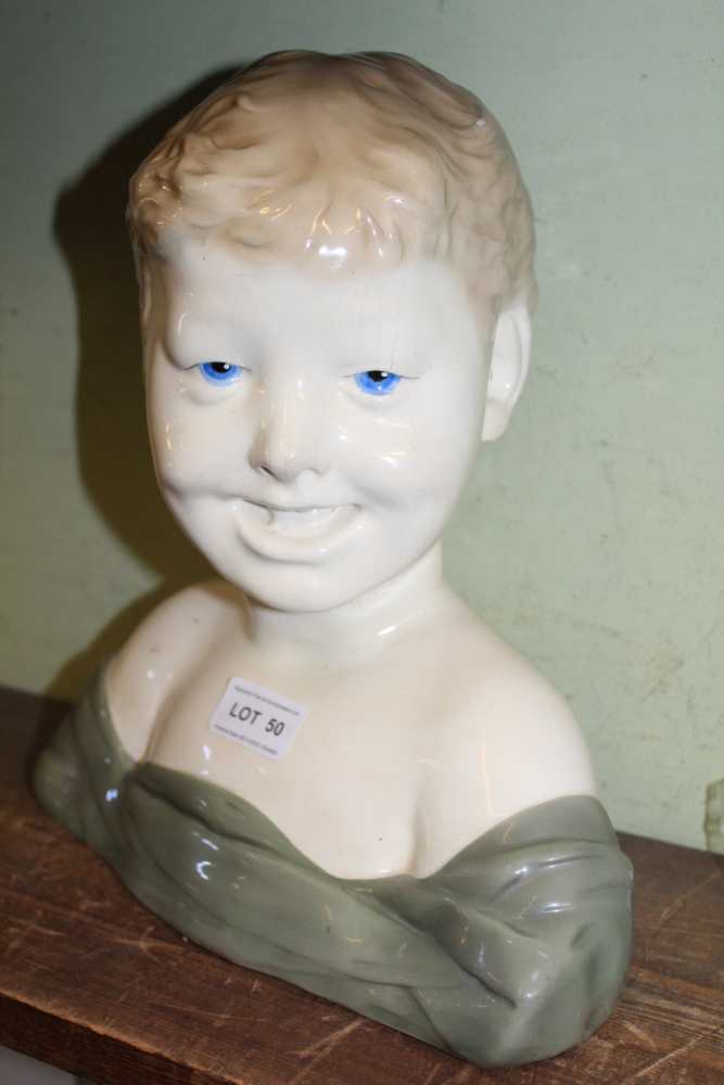 A CONTINENTAL POTTERY BUST OF A CHILD, 29cm high, (factory mark inside)