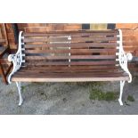 A WHITE PAINTED CAST METAL FRAMED SLATTED GARDEN TWO-SEATER BENCH together with two slatted single