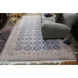 A ROOM SIZED TWO TONE WOVEN WOOLLEN FLOOR CARPET