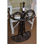 A BLACK PAINTED METAL DEMI-LUNE STICK STAND