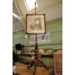 A 19TH CENTURY MAHOGANY POLE SCREEN with petit points needlework of a seated Scotsman, with open