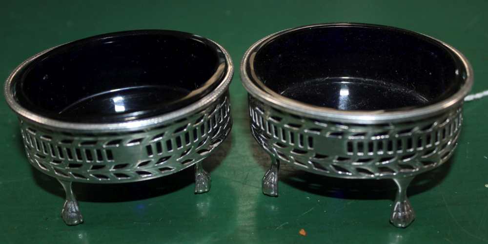 TWO HALLMARKED VICTORIAN SILVER SALTS with blue glass liners