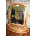 A LATE 19TH CENTURY ARCH TOPPED PLAIN PLATE ADJUSTABLE DRESSING TABLE MIRROR supported on a plinth