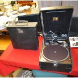 A SMALL VINYL COVERED WIND UP GRAMOPHONE together with a case of records
