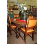 AN OAK DINING SUITE comprising; oval topped table with two extra leaves, supported on substantial