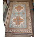 A WOVEN WOOL EAGLE KAZAKH (CHELABERD KARABAGH) PATTERNED FLOOR RUG with a pale blue central ground